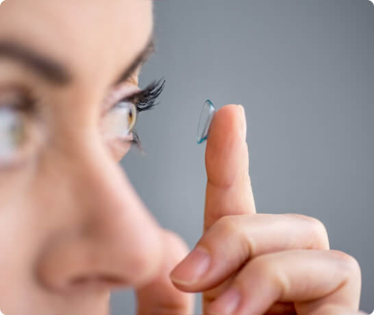 Woman putting on scleral lenses